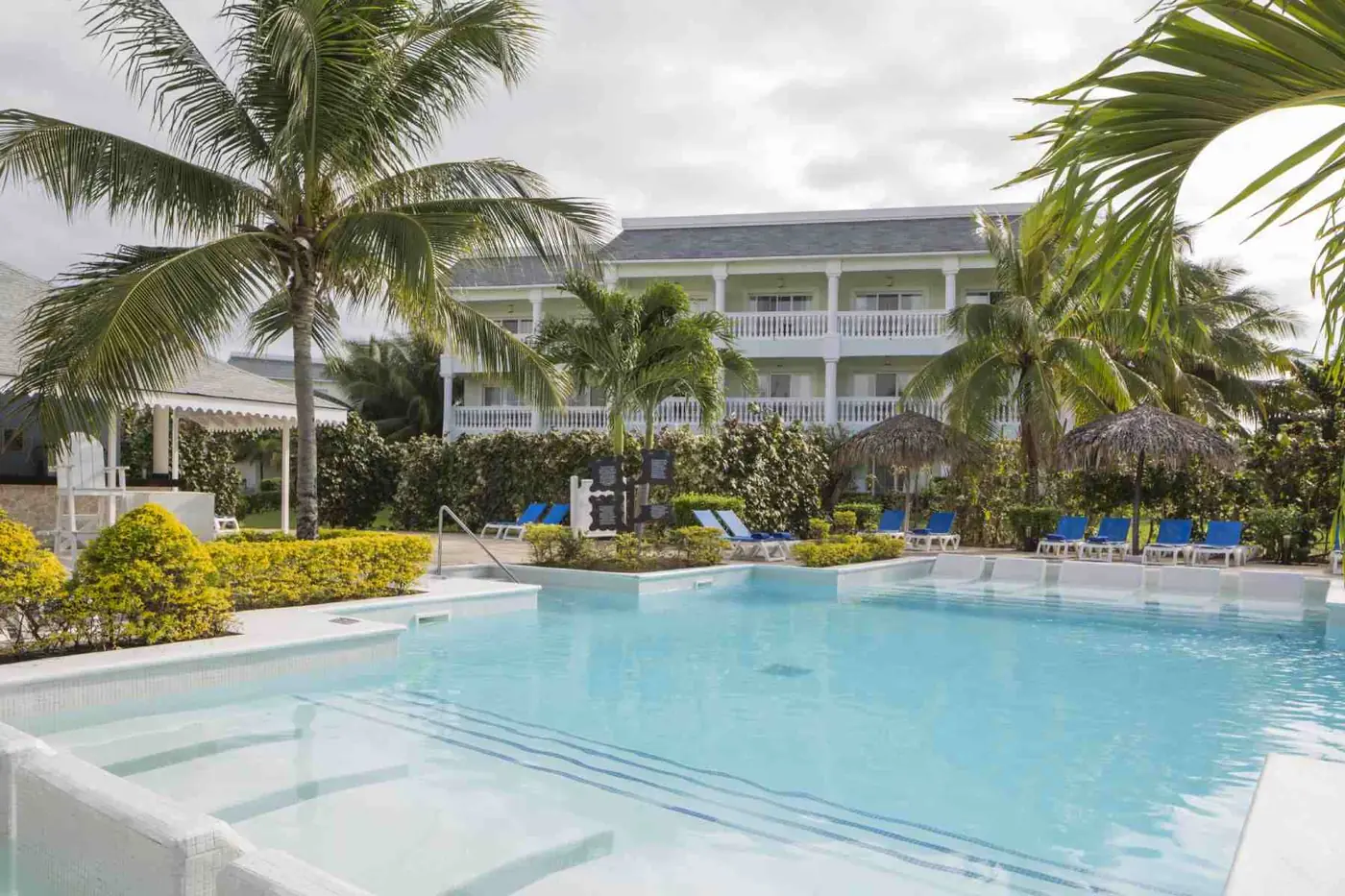 One of the resort pools, ringed by palms and plantation-style suites
